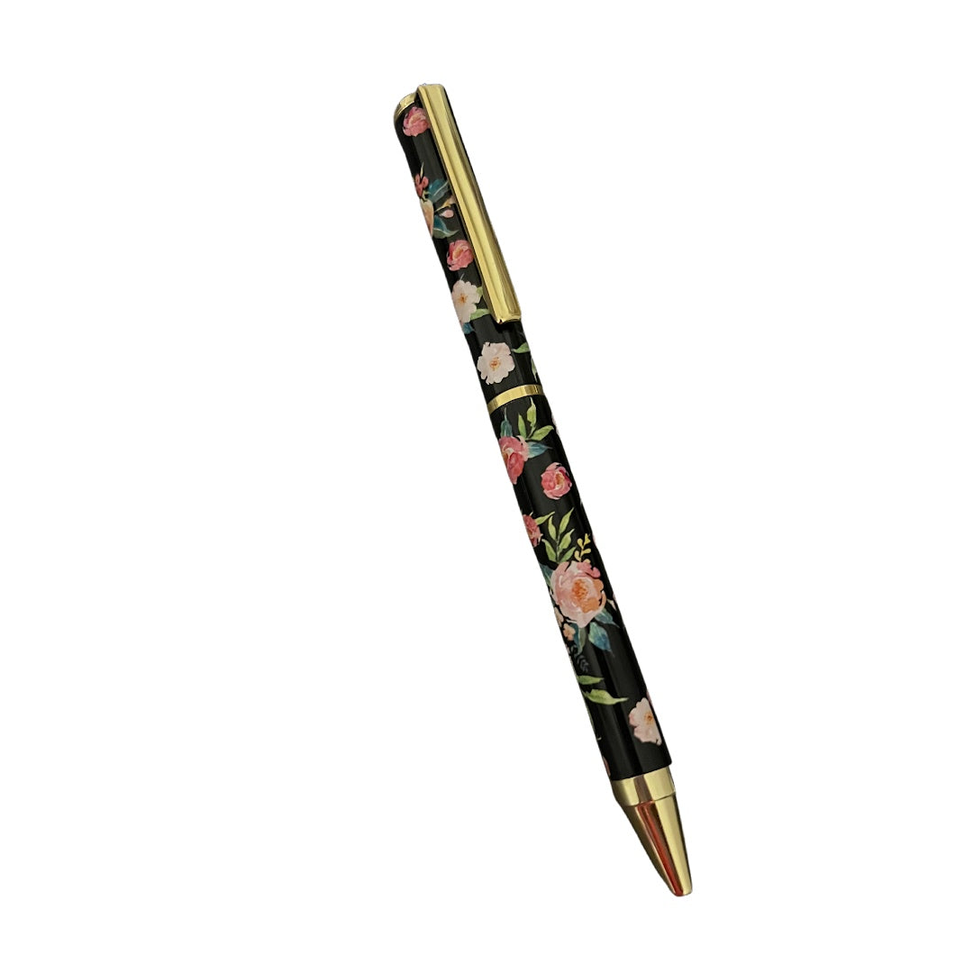 a black pen covered in flowers with gold accents